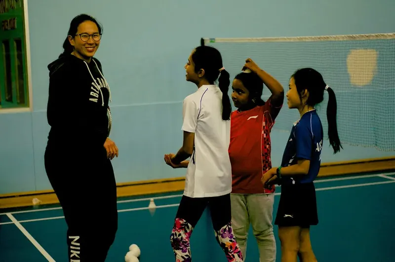 A Westside coach smiling with young players on court