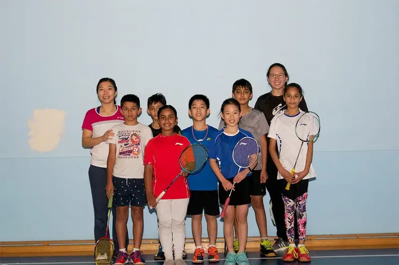 Coaches and students lined up together on court
